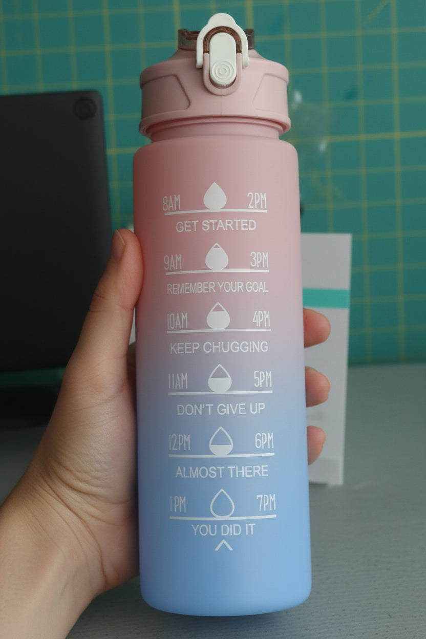 Gradient water bottle with motivational text held by a hand against a green grid background