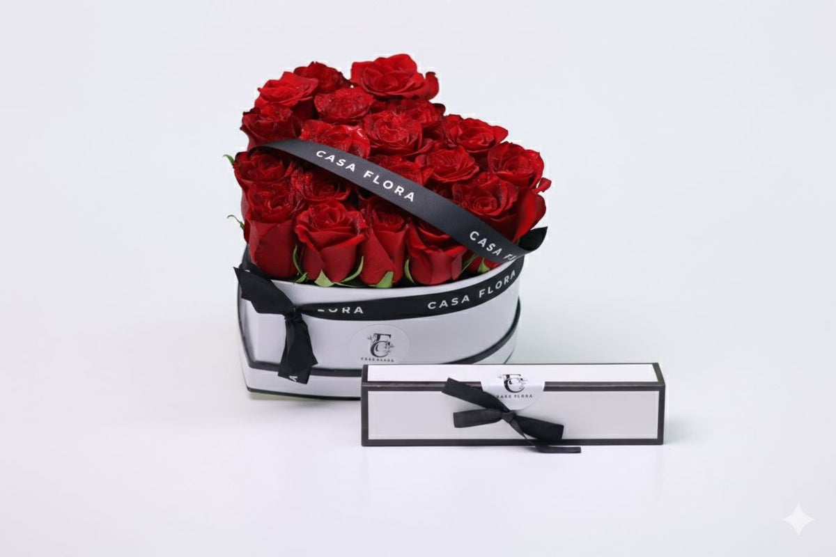 Heart-shaped box of red roses with 'Casa Flora' branding on a white background