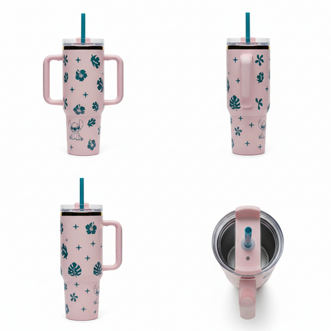 Pink tumbler with floral design and handle on a white background